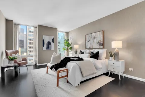 a bedroom with a bed and lamp