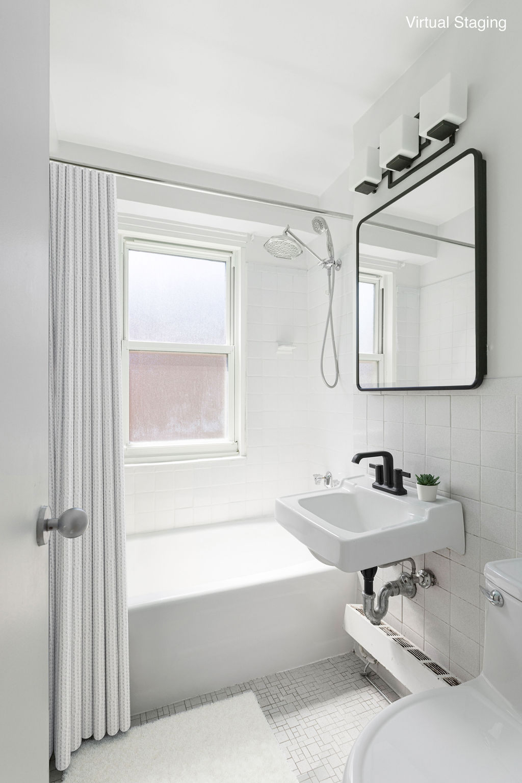 101 West 12th Street, Unit 5V Manhattan, NY 10011 - Photo 7 of 26 a bathroom with a bathtub and a mirror
