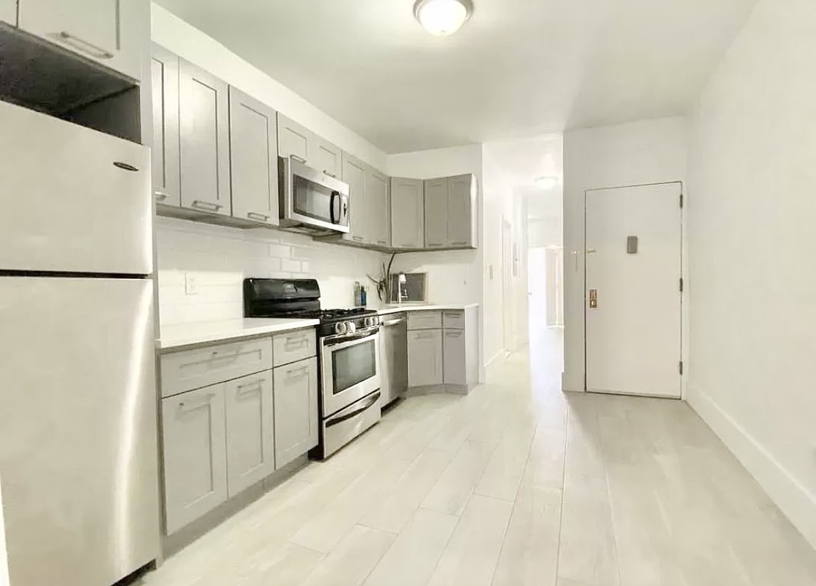 414 Prospect Avenue, Unit 2R Brooklyn, NY 11215 - Photo 1 of 5 a kitchen with white cabinets and white appliances
