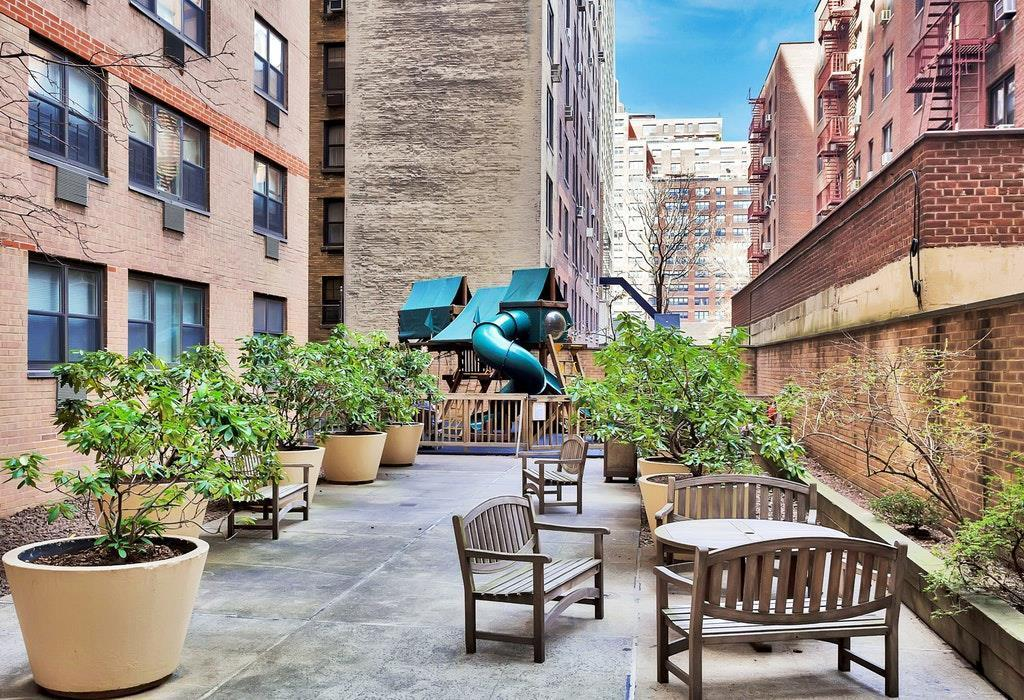 340 East 80th Street, Unit 1D Manhattan, NY 10075 - Photo 13 of 15 a view of a patio with couches and a potted plant