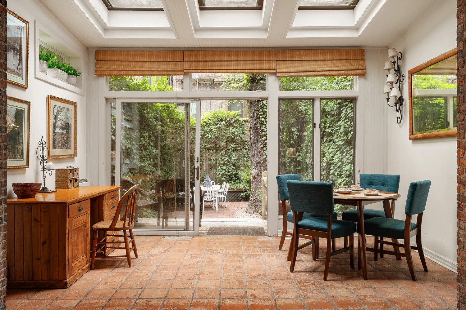 a dining room with furniture and large windows