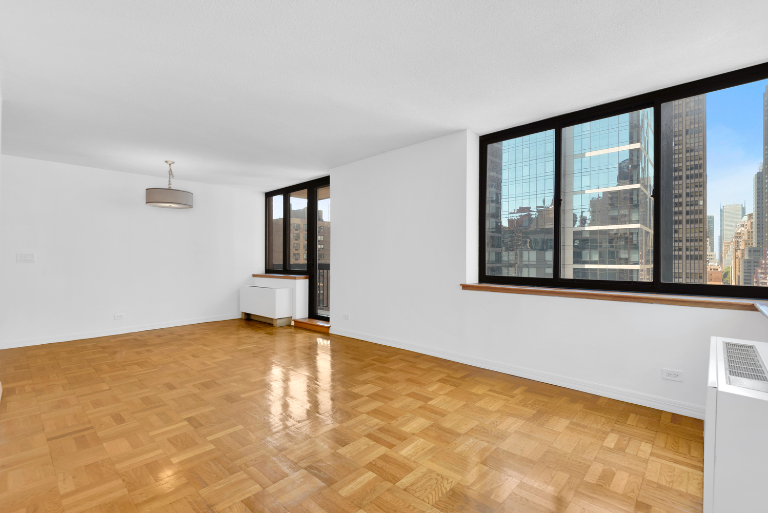 250 East 40th Street, Unit 22B Manhattan, NY 10016 - Photo 2 of 13 a view of an empty room with window