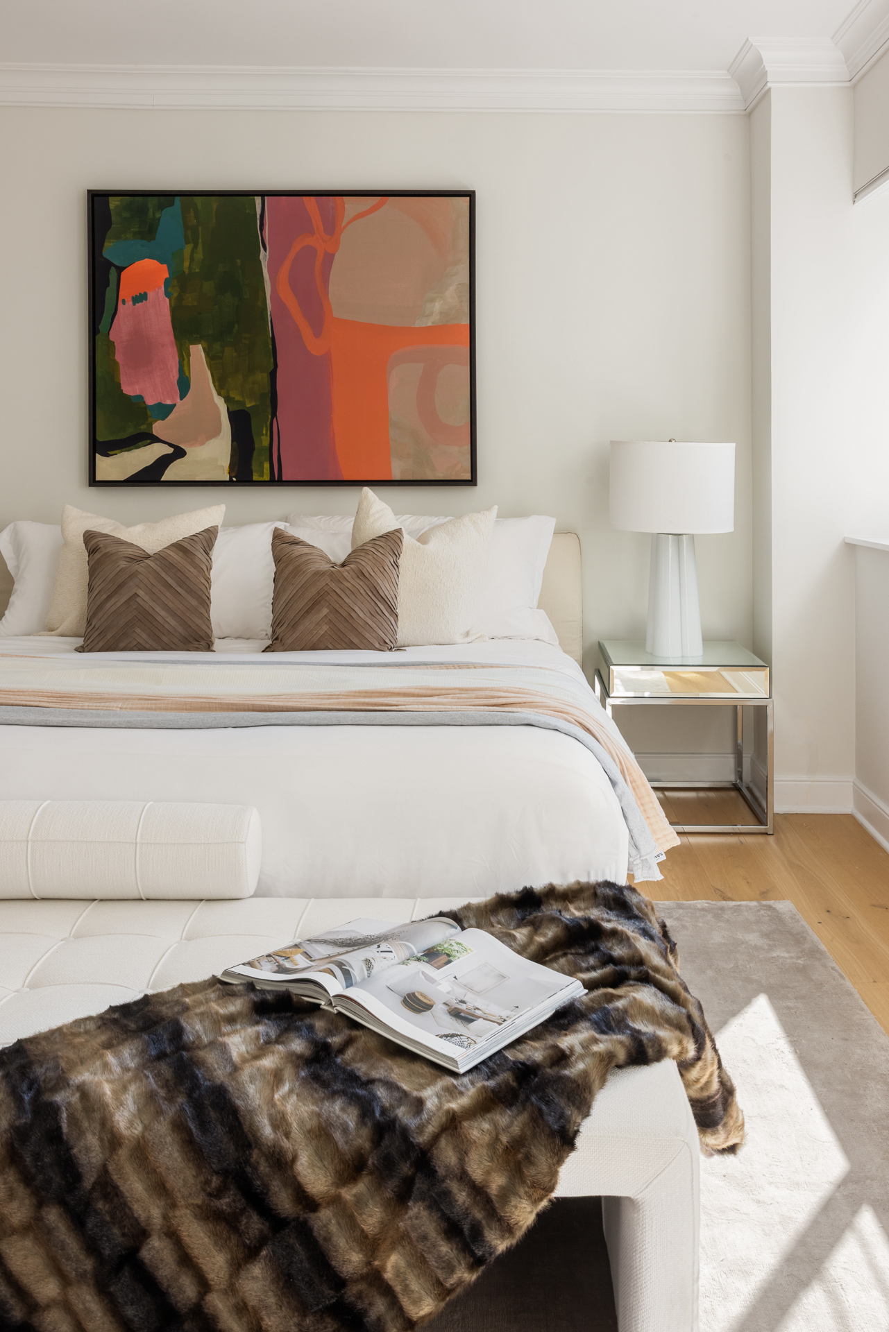 32 East 76th Street, Unit 805 Manhattan, NY 10021 - Photo 4 of 15 a bed sitting in a bedroom next to a lamp