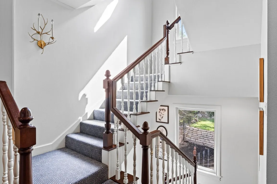 a view of an empty room with a window and a flat screen tv