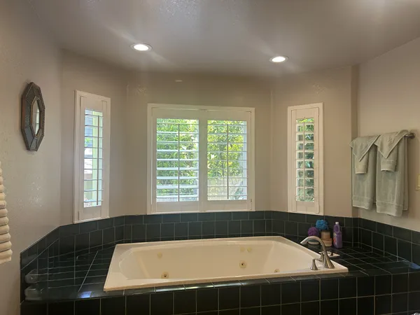 a bathroom with a bathtub and a shower
