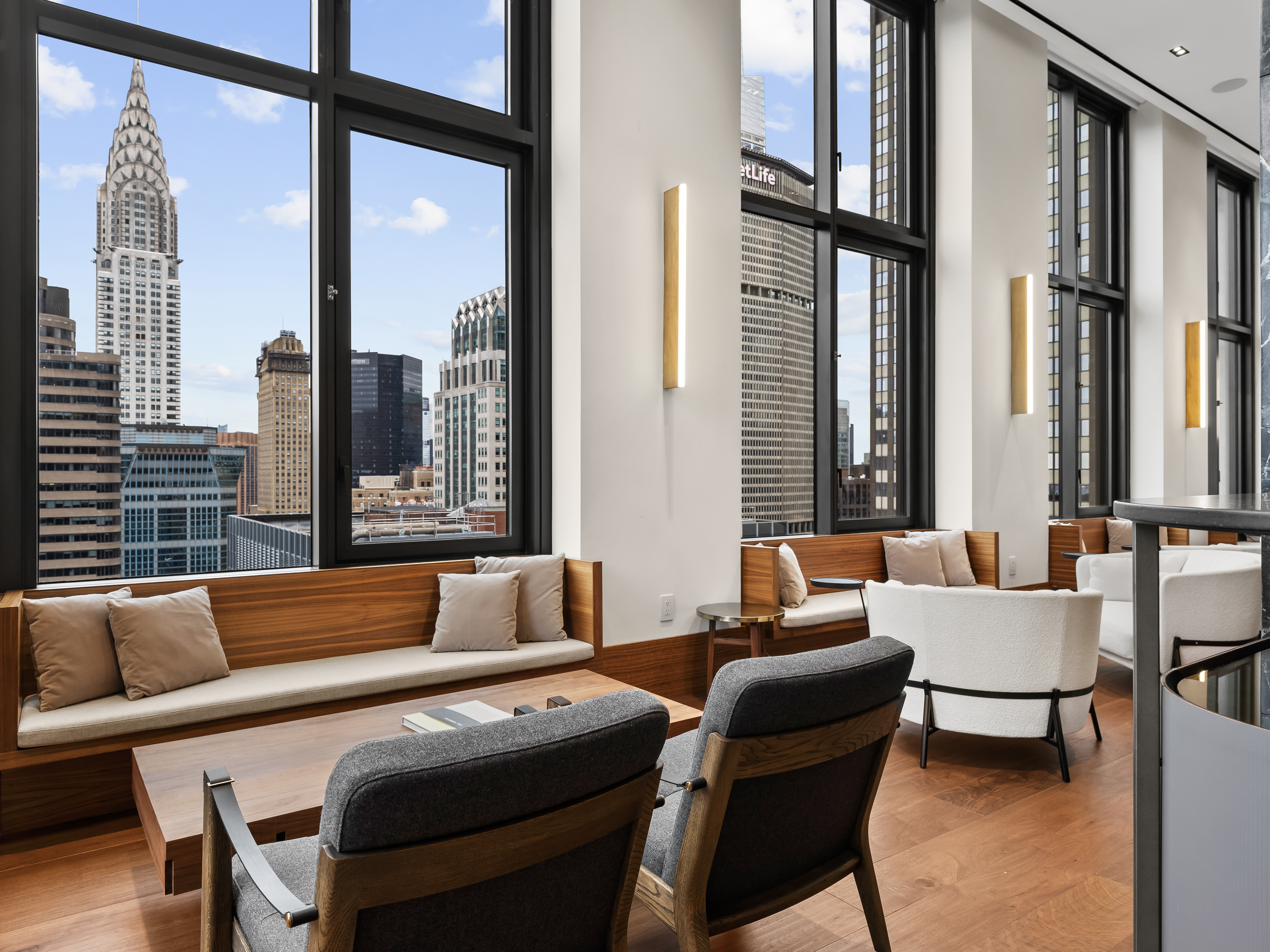 135 East 47th Street, Unit 4F Manhattan, NY 10017 - Photo 10 of 11 a living room with furniture and a large window