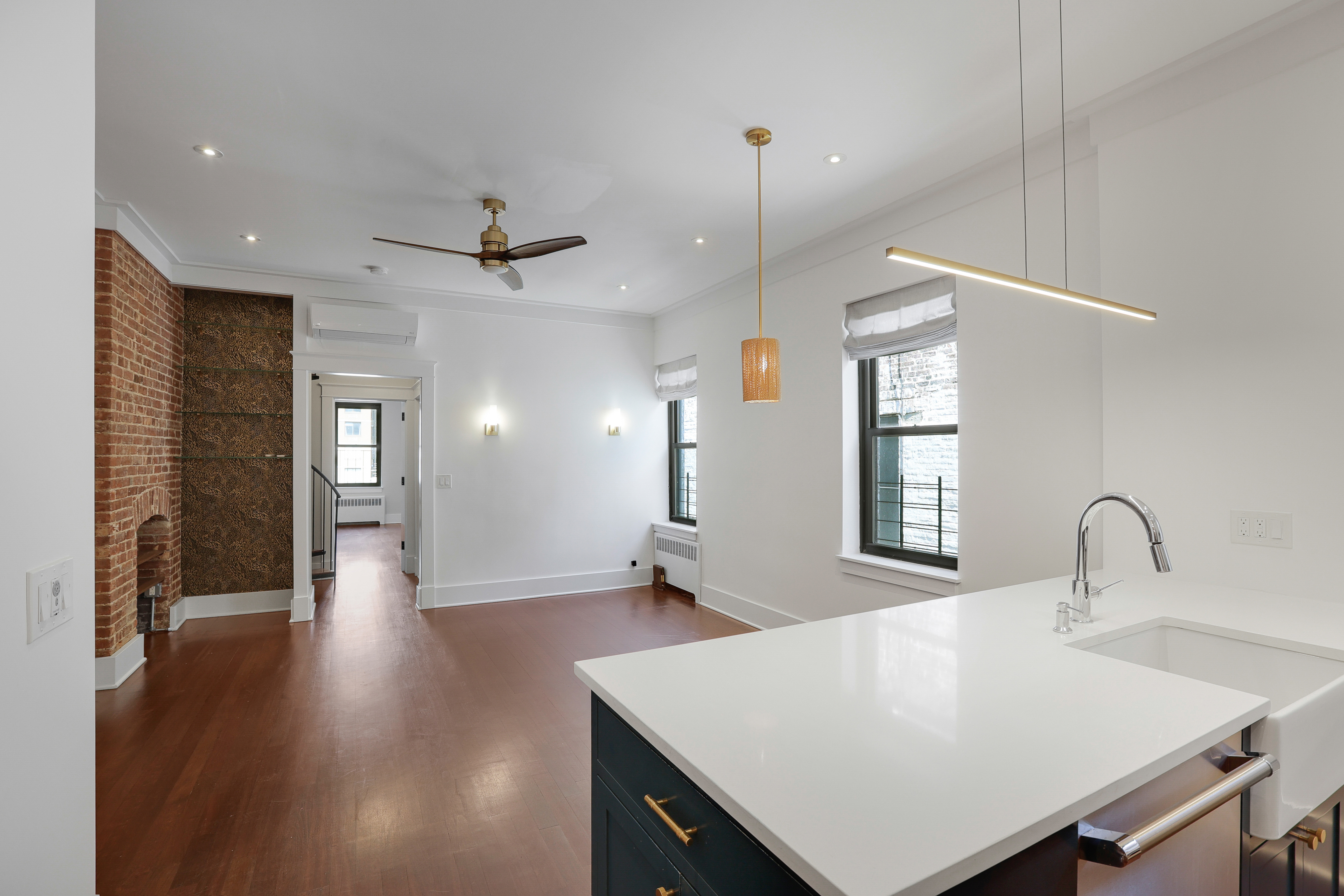 133 East 30th Street, Unit PH5B Manhattan, NY 10016 - Photo 13 of 24 a view of a kitchen with a sink dishwasher a refrigerator and wooden floor