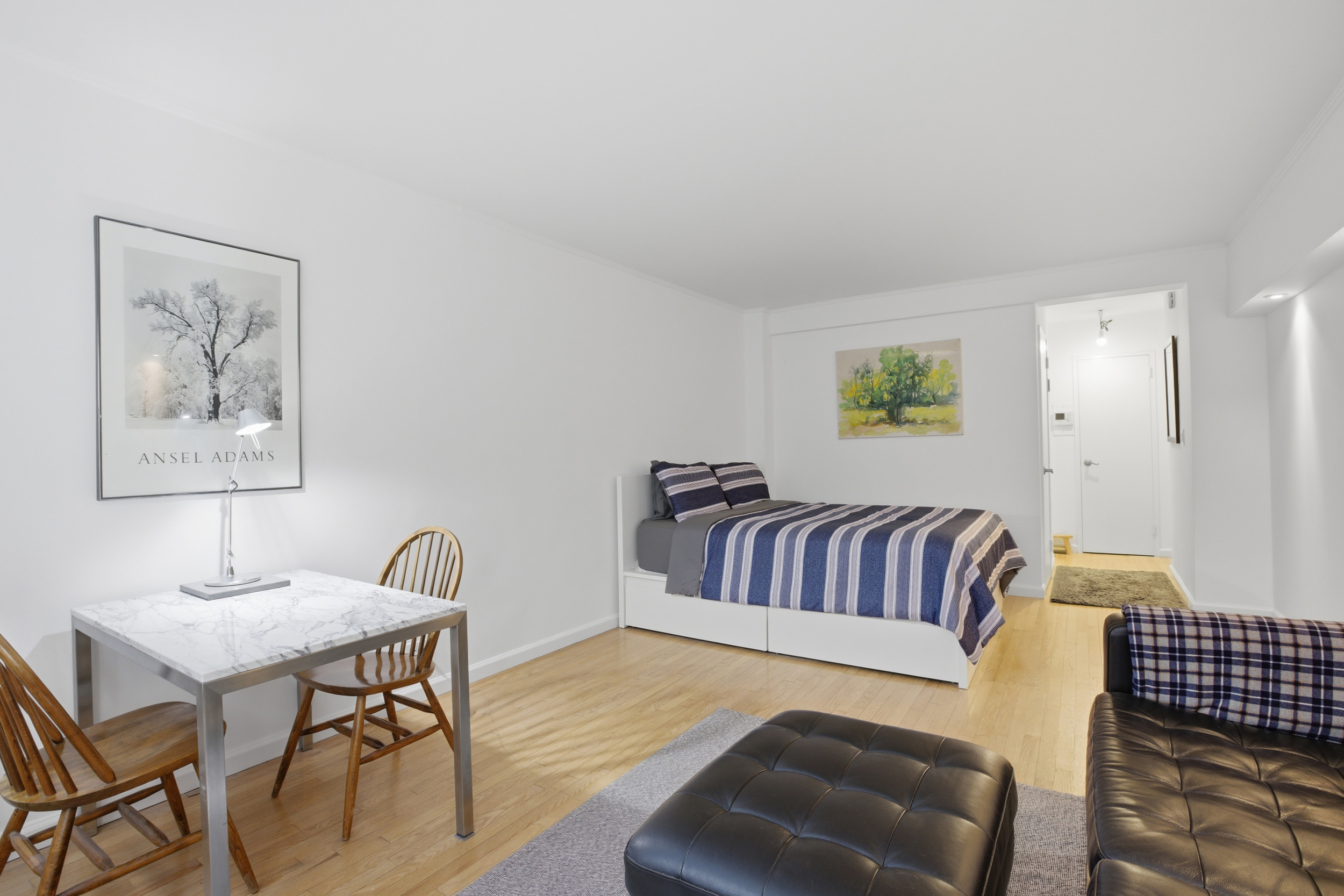 321 East 45th Street, Unit 2H Manhattan, NY 10017 - Photo 2 of 5 a bedroom with furniture and a couch