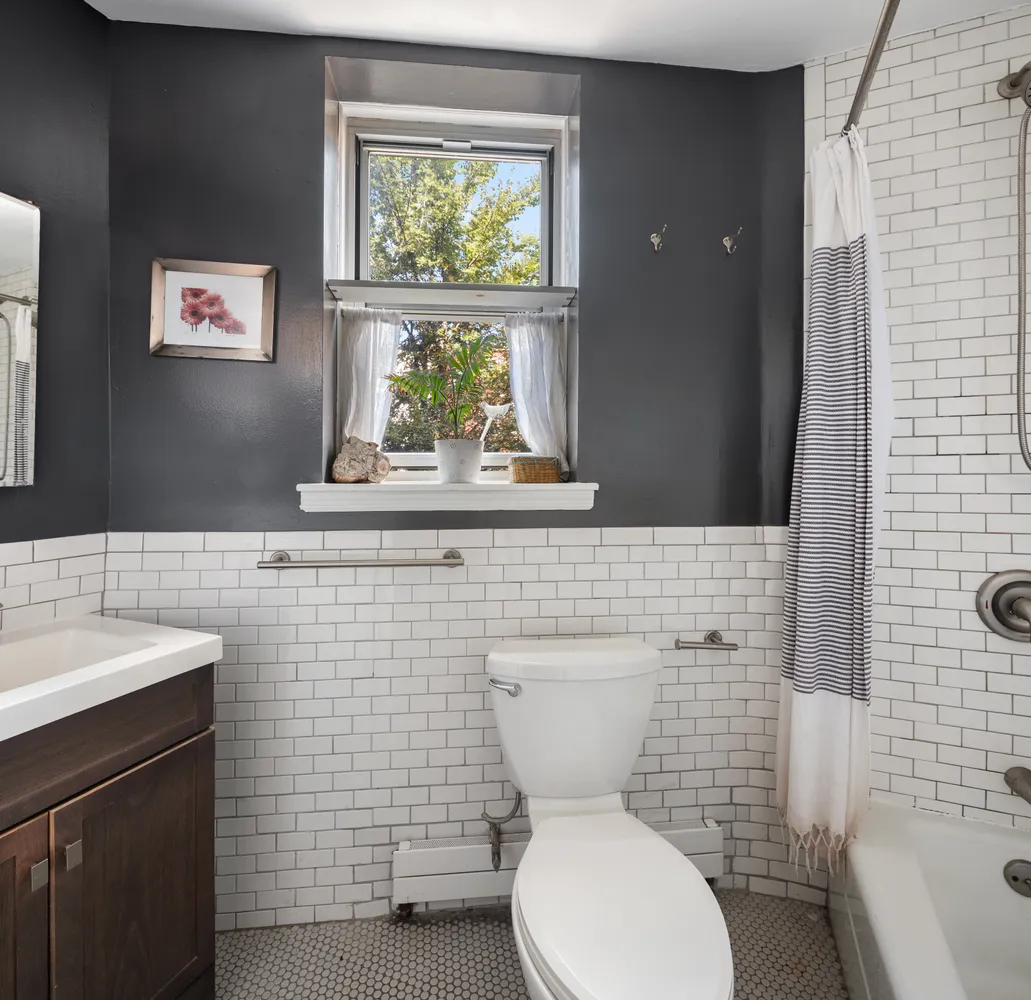 a bathroom with a toilet sink and mirror