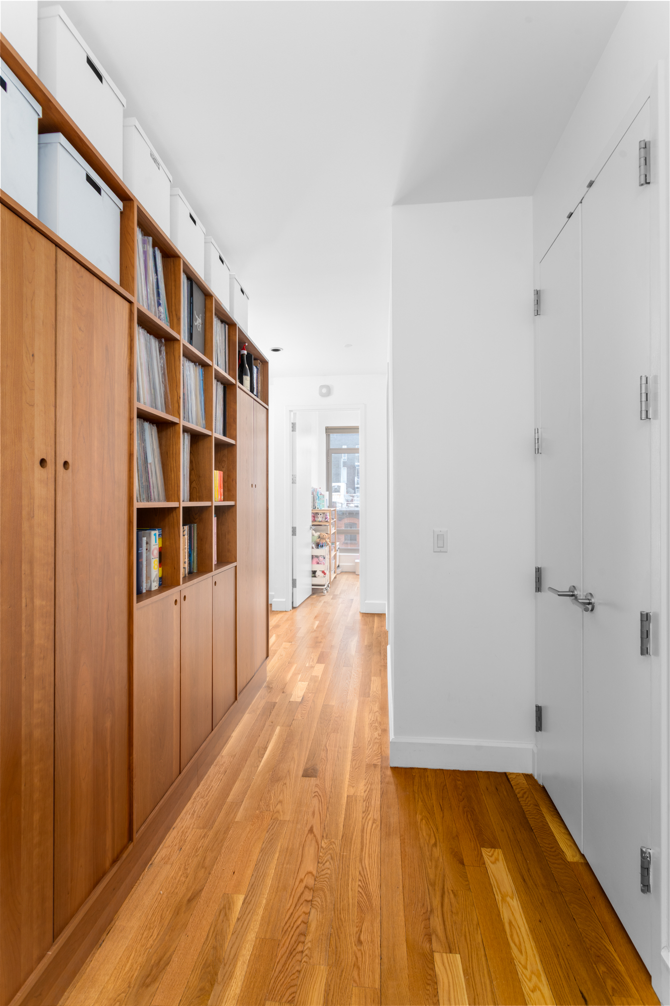 315 Gates Avenue, Unit 4E Brooklyn, NY 11216 - Photo 4 of 17 a view of empty room with wooden floor and cabinet