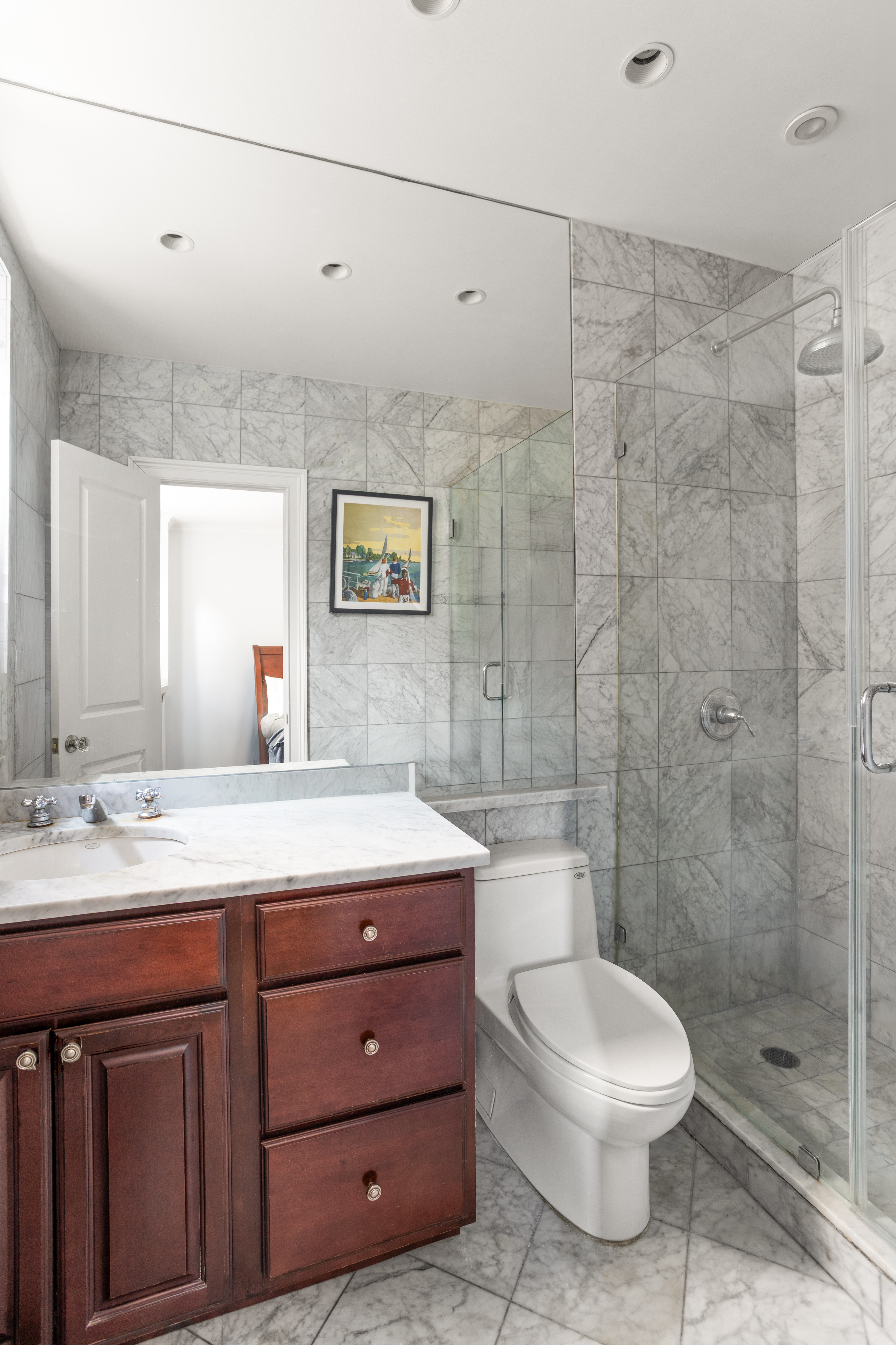 161 East 90th Street, Unit 5C Manhattan, NY 10128 - Photo 8 of 14 a bathroom with a sink a toilet and shower