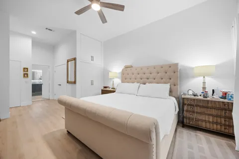 a bedroom with a bed and a night stand