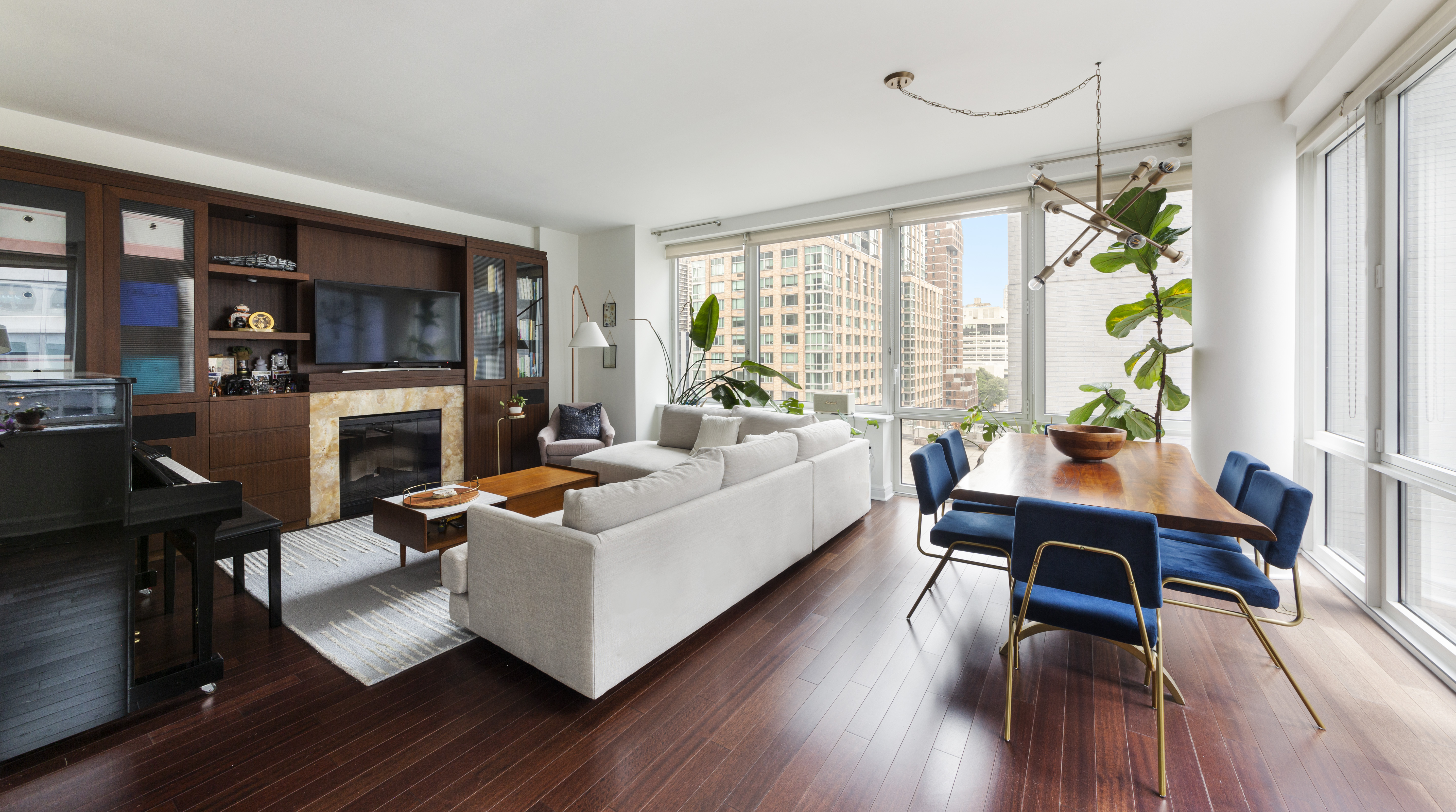 80 Riverside Boulevard, Unit 9E Manhattan, NY 10069 - Photo 2 of 14 a living room with furniture a fireplace and a flat screen tv