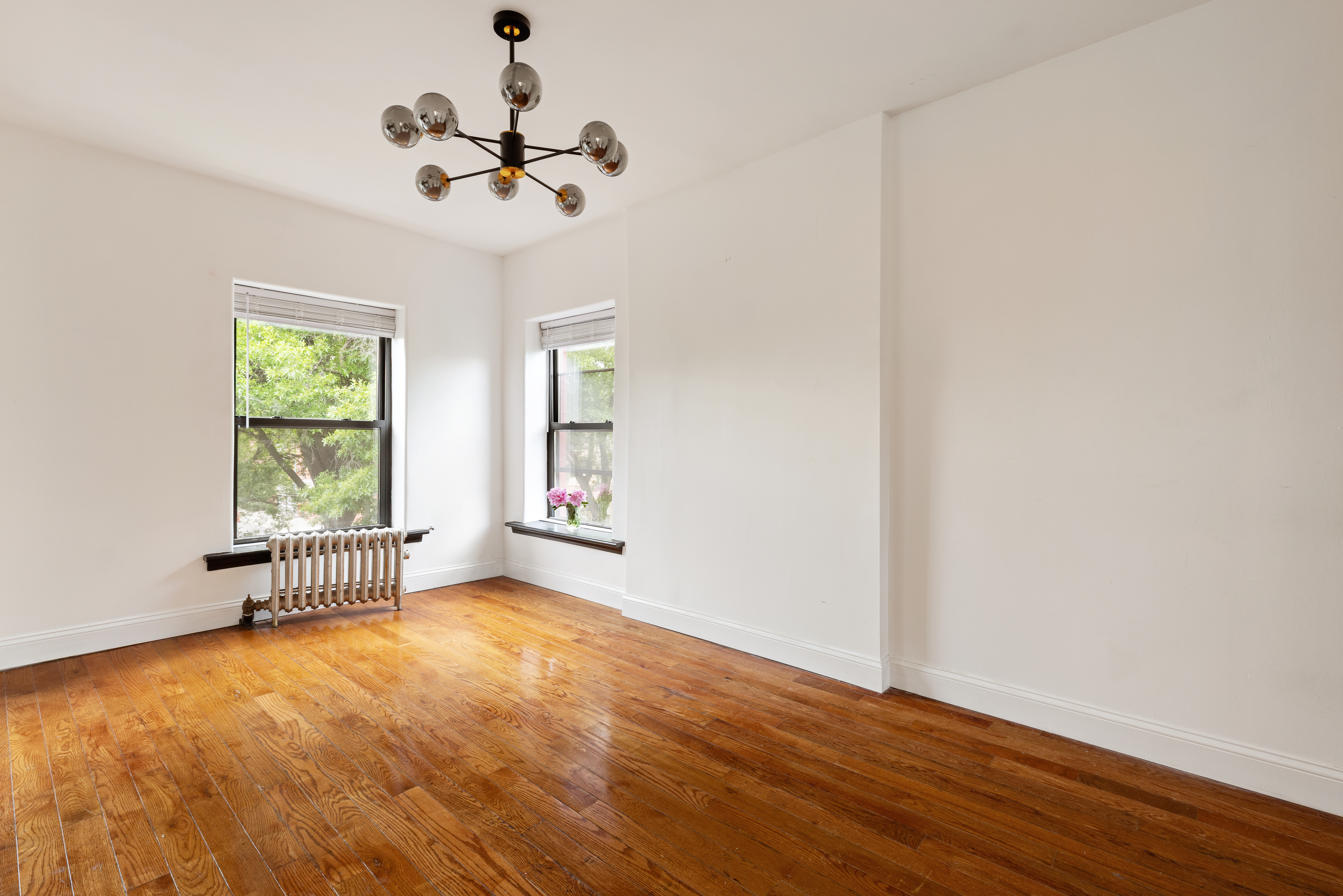 663 Greene Avenue Brooklyn, NY 11221 - Photo 9 of 14 wooden floor in an empty room with a window