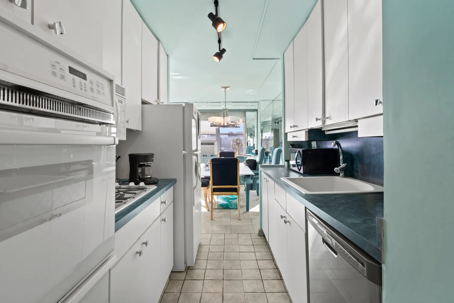 a kitchen with stainless steel appliances a stove refrigerator and cabinets
