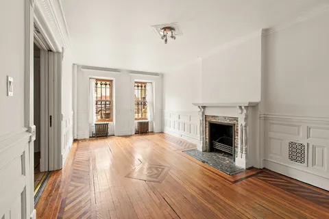 a view of a livingroom with a fireplace and window