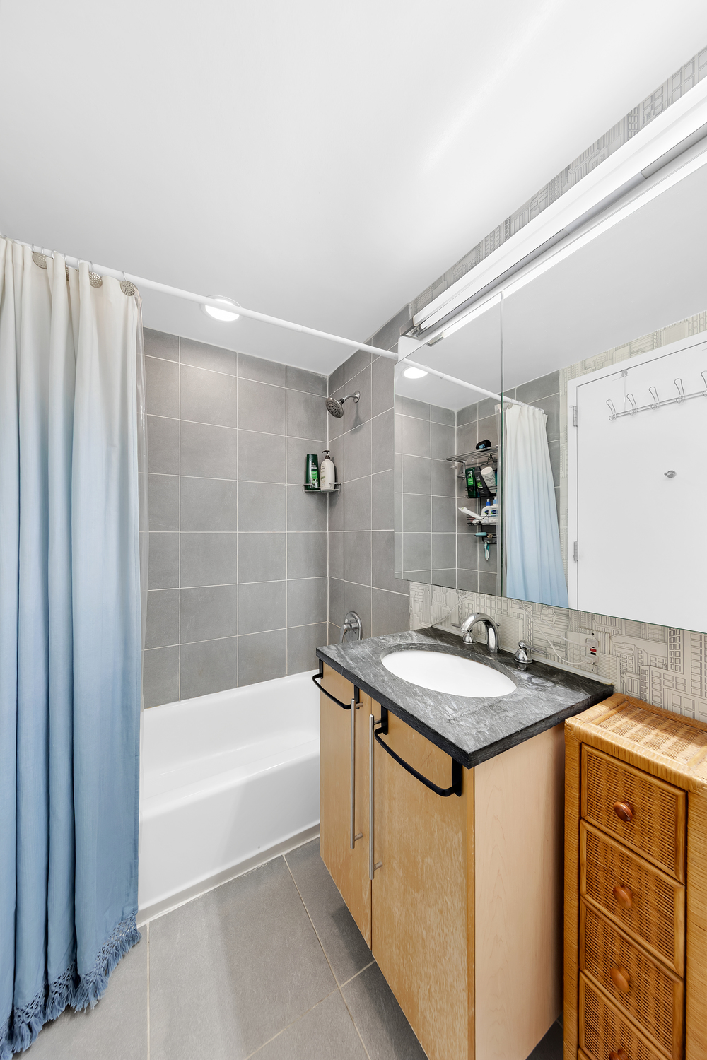 242 East 25th Street, Unit 9B Manhattan, NY 10010 - Photo 5 of 6 a bathroom with a granite countertop sink and a mirror