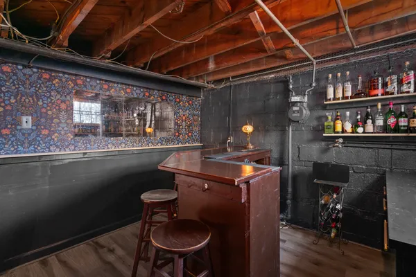 a kitchen with a sink a stove and a wooden floor