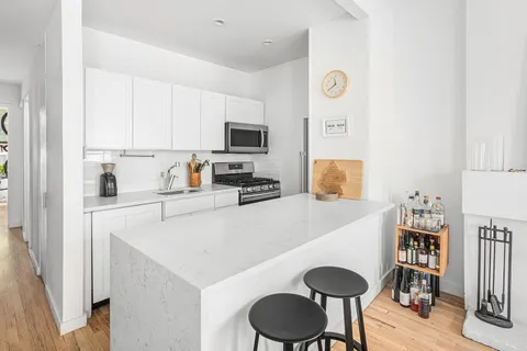 a kitchen with a sink a stove and a refrigerator