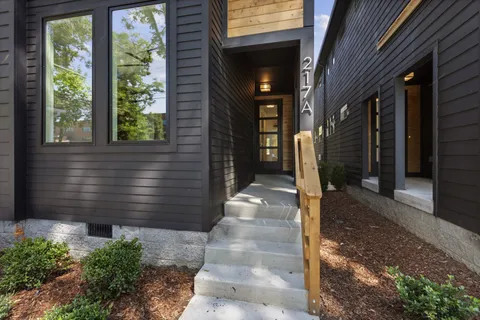 a view of a hallway with wooden floor and entryway