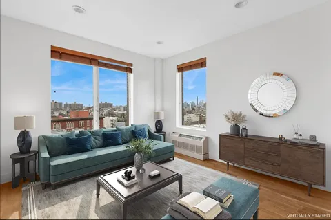 a living room with furniture a rug and a large window