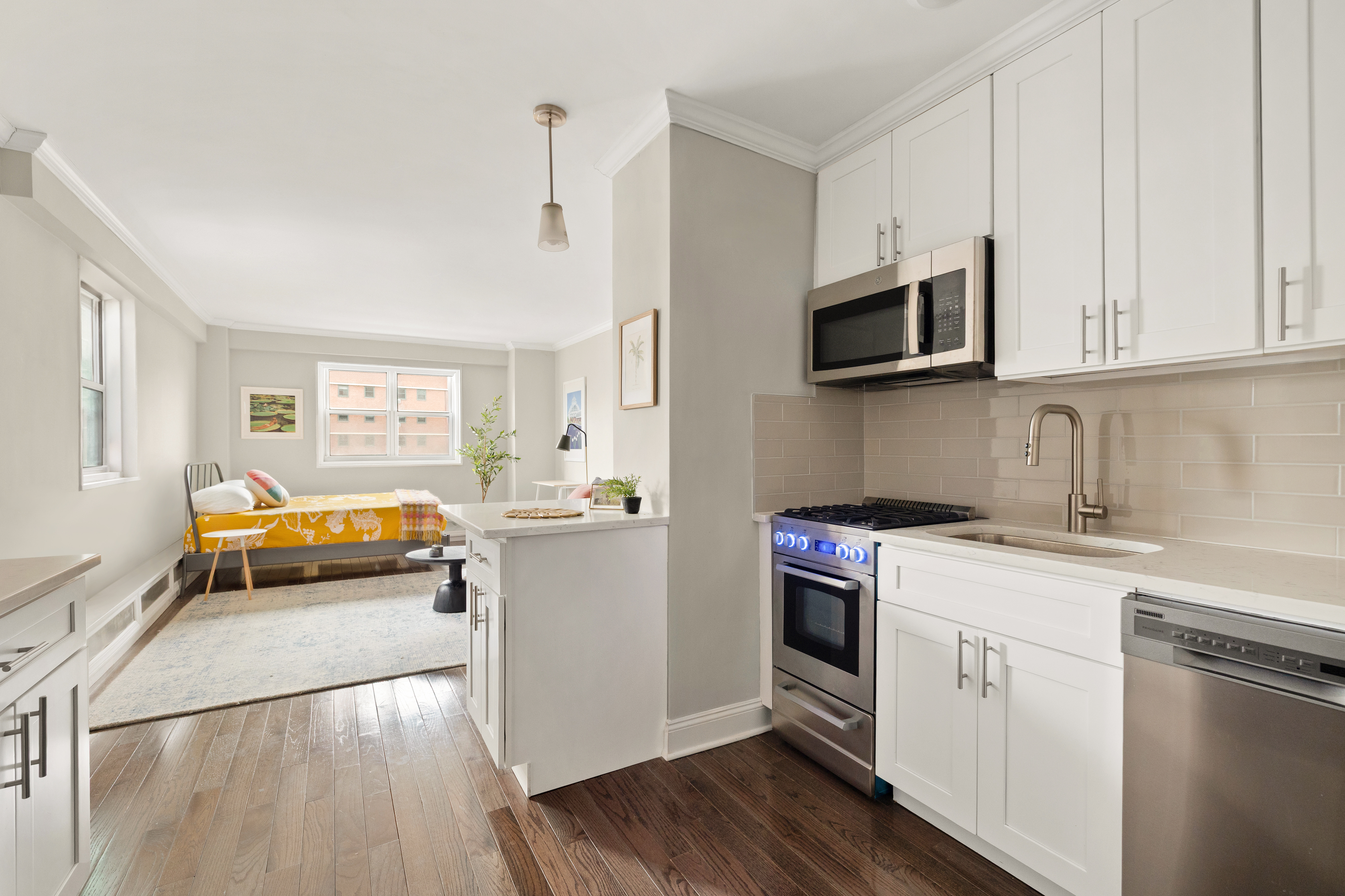 191 Willoughby Street, Unit 7/F Brooklyn, NY 11201 - Photo 4 of 15 a kitchen with stainless steel appliances granite countertop white cabinets a sink and dishwasher a stove with wooden floor