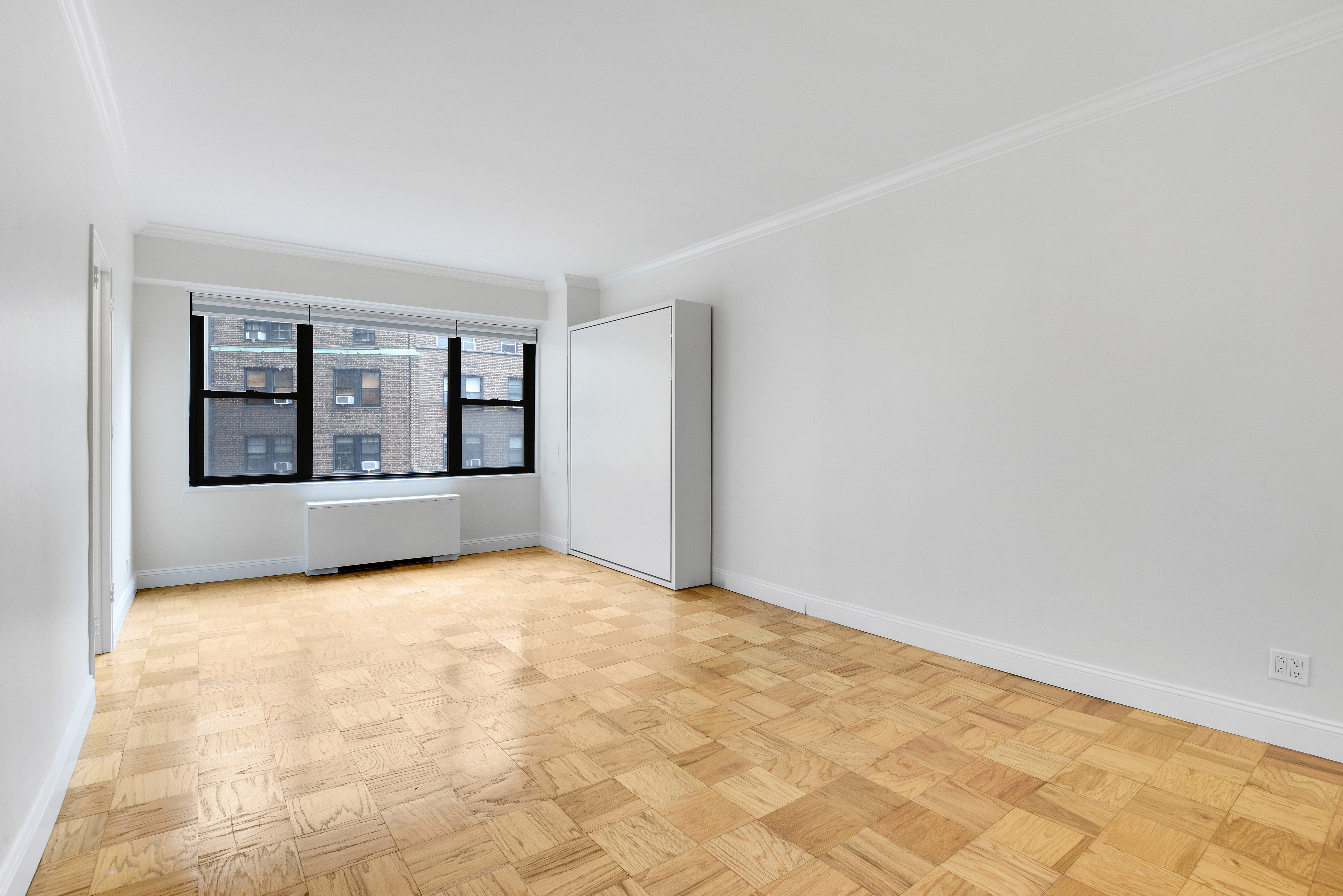 305 East 40th Street, Unit 14V Manhattan, NY 10016 - Photo 9 of 26 a view of an empty room with a fireplace