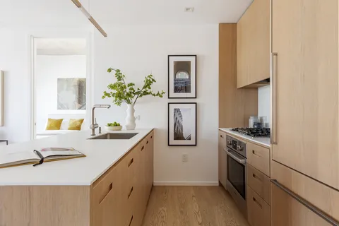 a kitchen with a sink stove and refrigerator