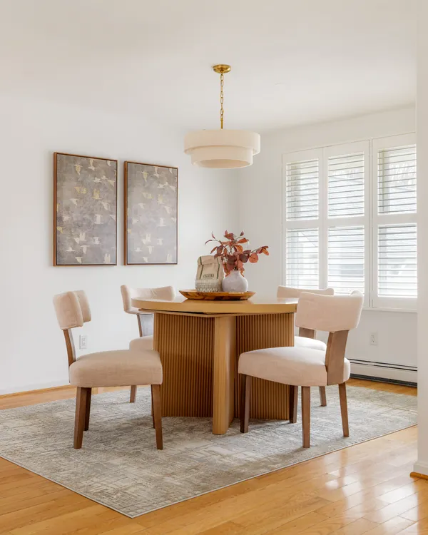 a dining room with furniture and window