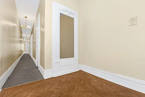 a view of a big room with wooden floor and a bathroom