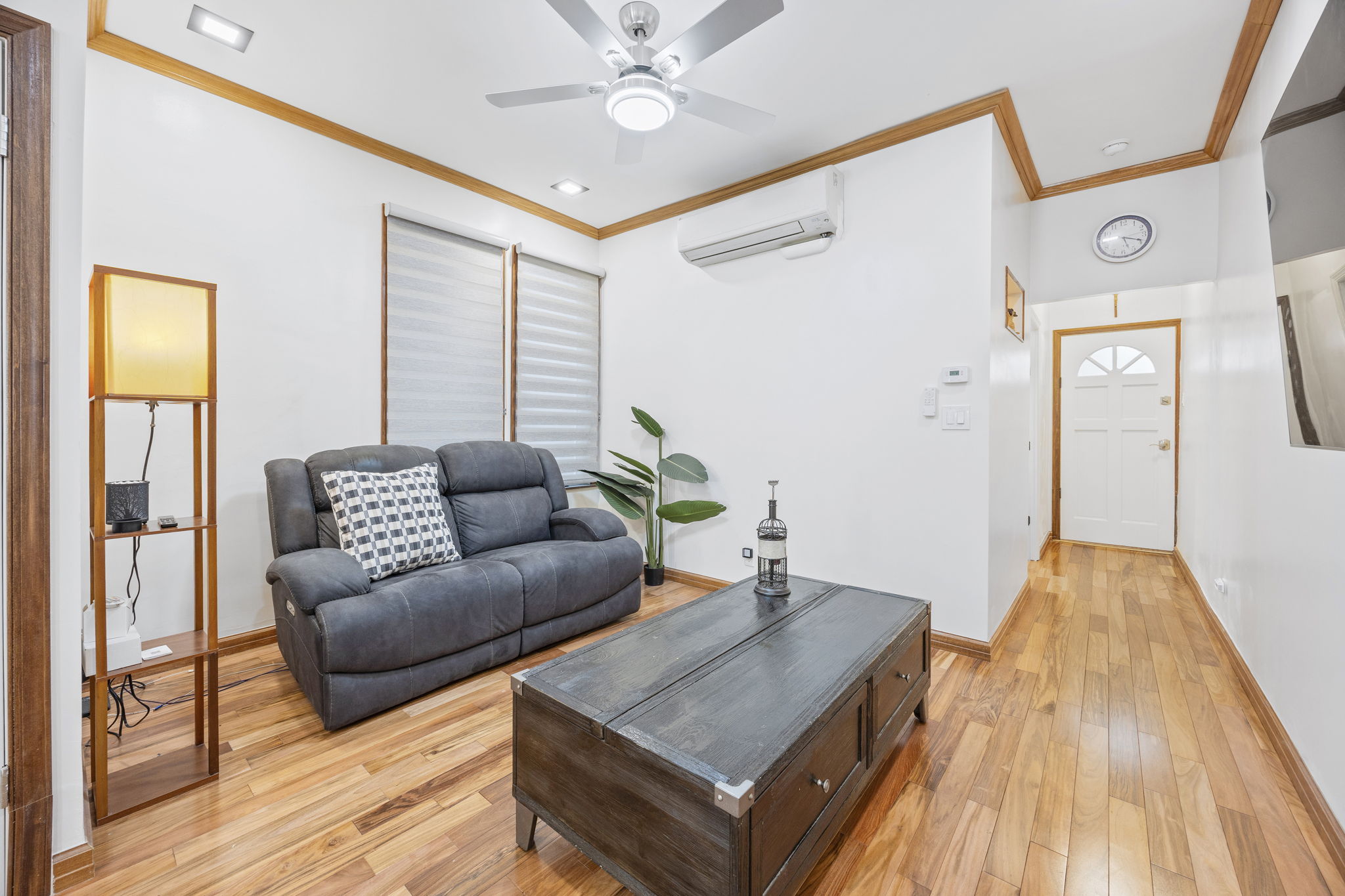 25-69 46th Street Queens, NY 11103 - Photo 17 of 33 a living room with furniture and a wooden floor