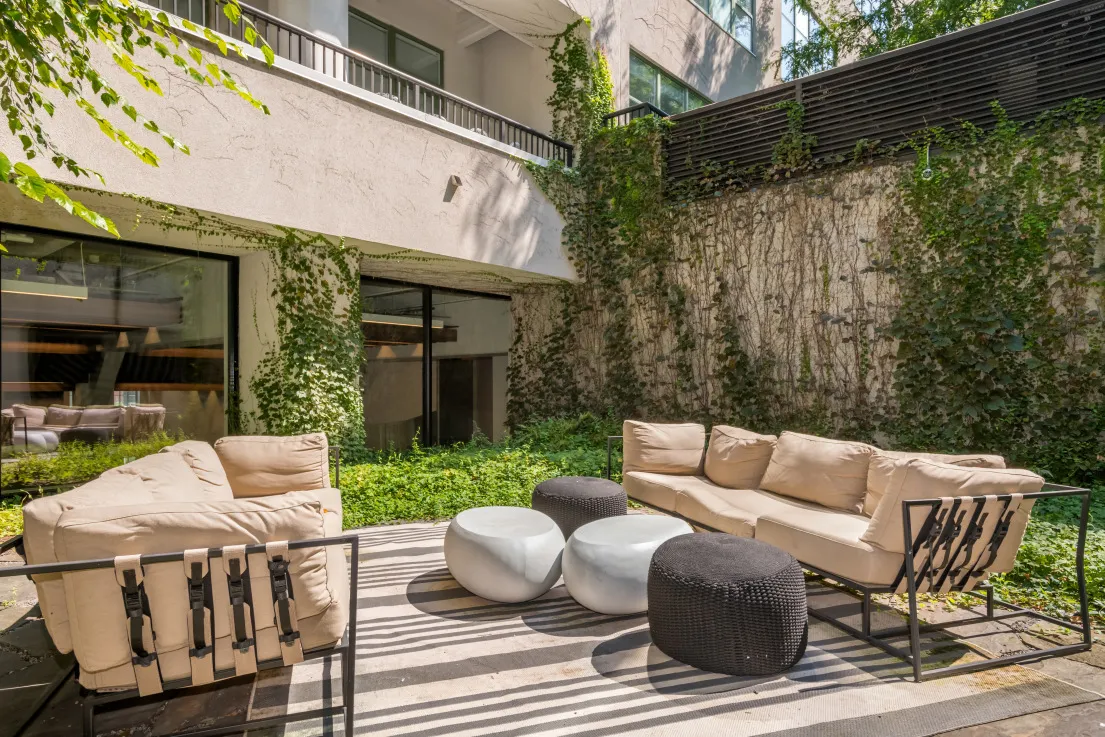a view of a patio with a table and chairs