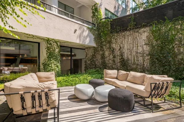 a view of a patio with a table and chairs
