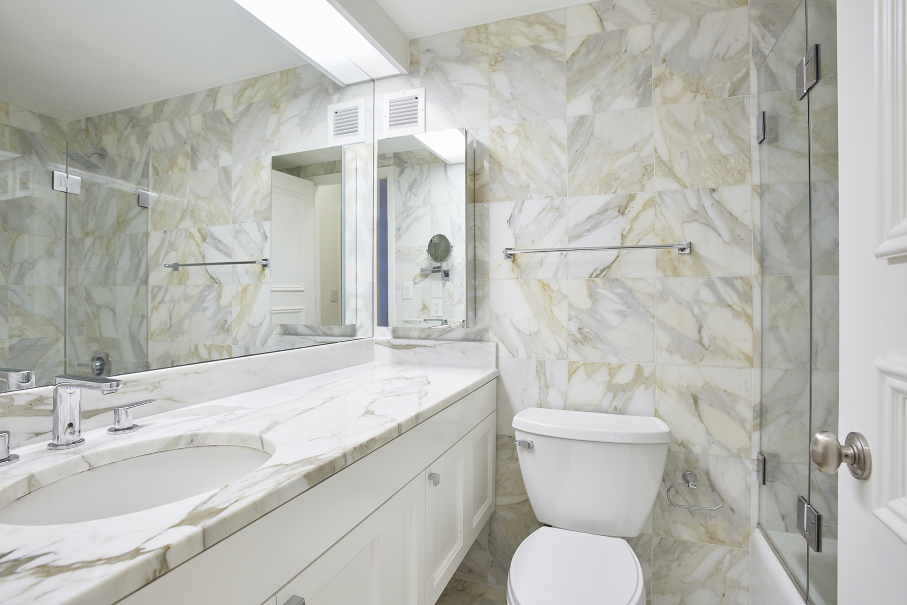 188 East 70th Street, Unit 8C Manhattan, NY 10021 - Photo 6 of 15 a bathroom with a granite countertop sink toilet and shower