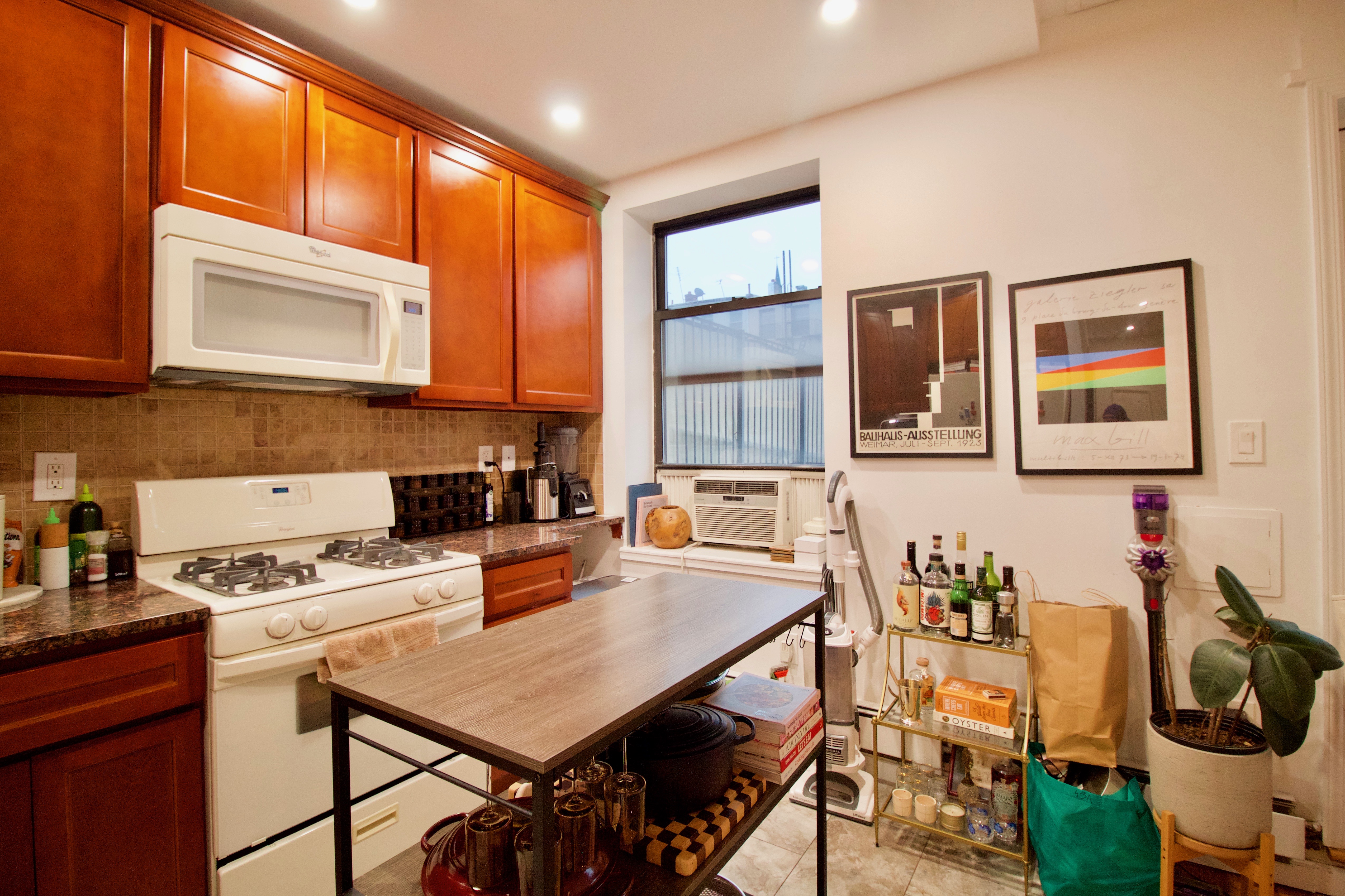 134 Union Street, Unit 2R Brooklyn, NY 11231 - Photo 5 of 37 a kitchen with a dining table chairs and a refrigerator