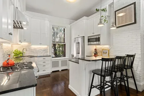 a view of kitchen with furniture and wooden floor