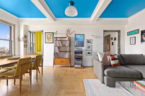 a living room with furniture and a floor to ceiling window