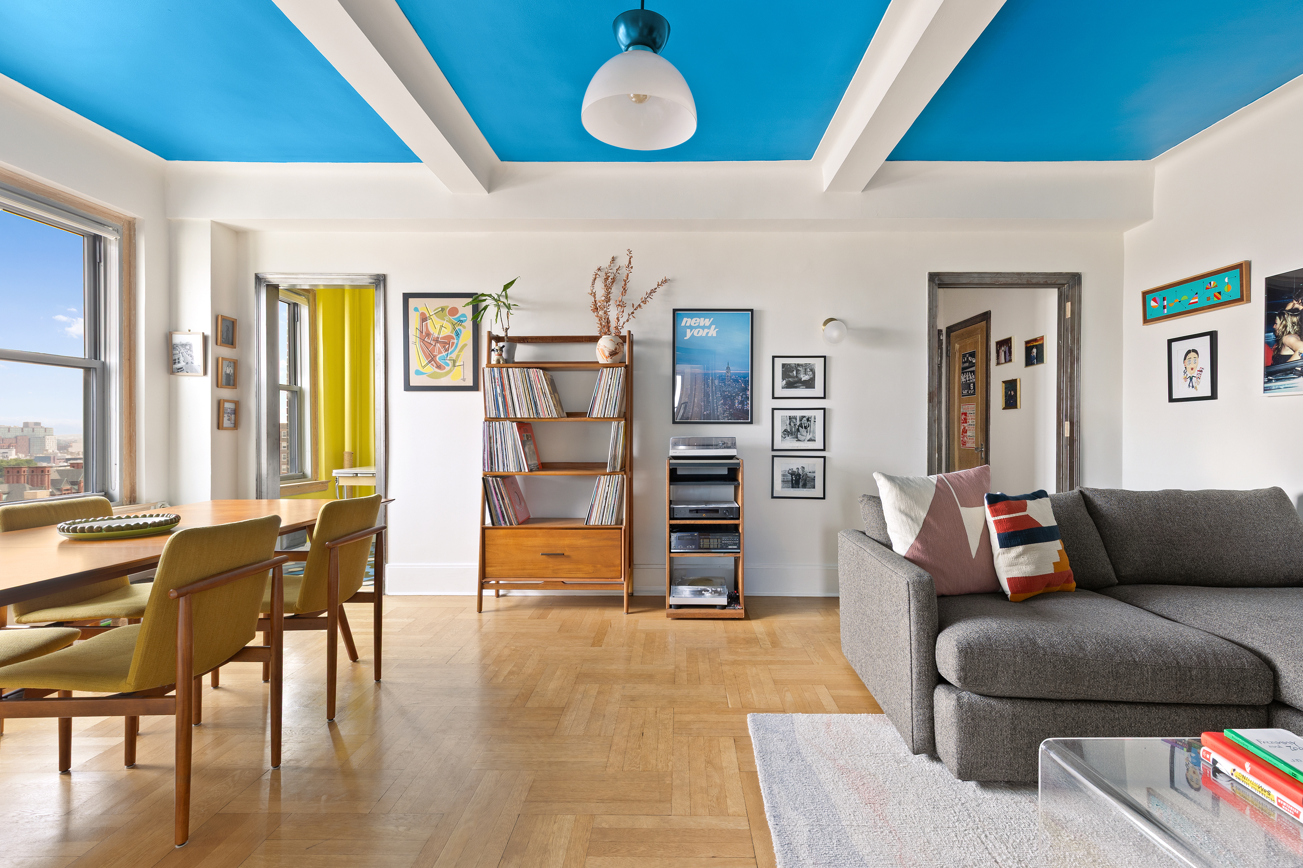a living room with furniture and a floor to ceiling window