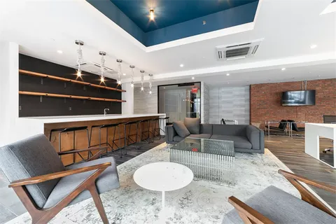 a living room with furniture a dining table and a fireplace