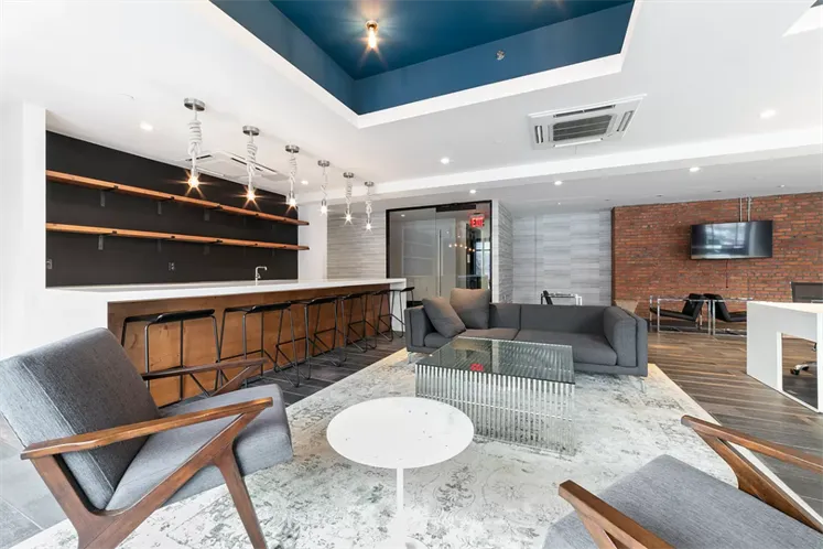 a living room with furniture a dining table and a fireplace