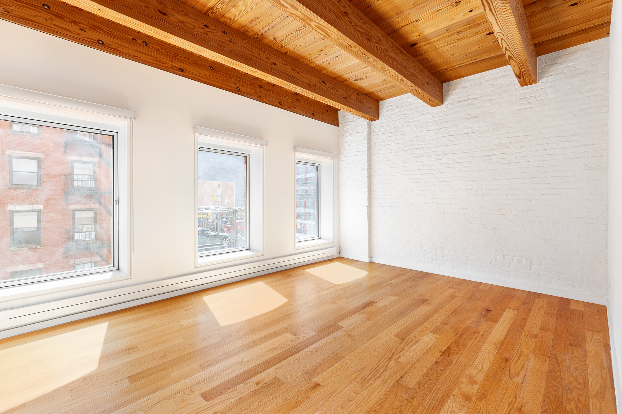 136 Baxter Street, Unit 3C Manhattan, NY 10013 - Photo 10 of 15 a view of empty room with wooden floor and fan