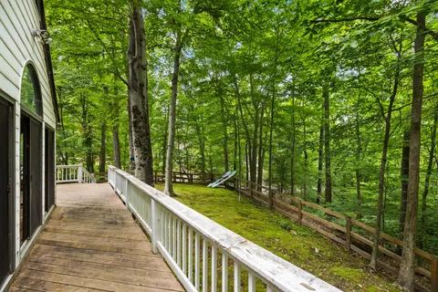 a view of balcony with furniture and trees