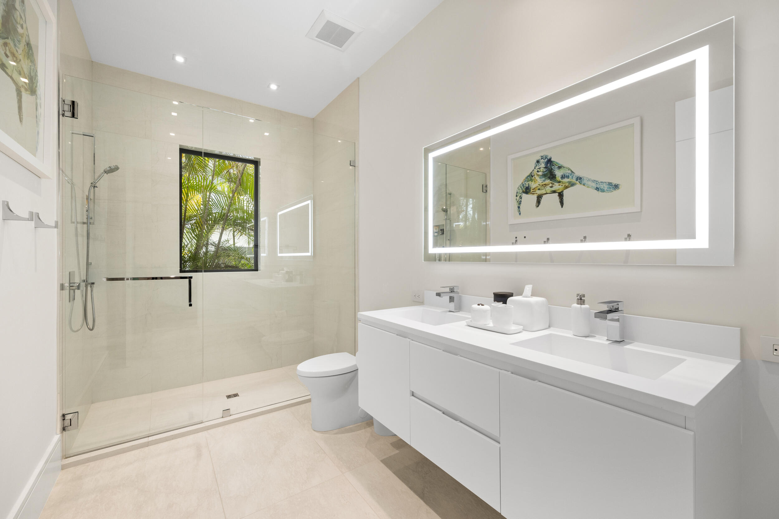 5695 Pennock Point Road Jupiter, FL 33458 - Photo 56 of 77 a bathroom with a double vanity sink mirror and toilet