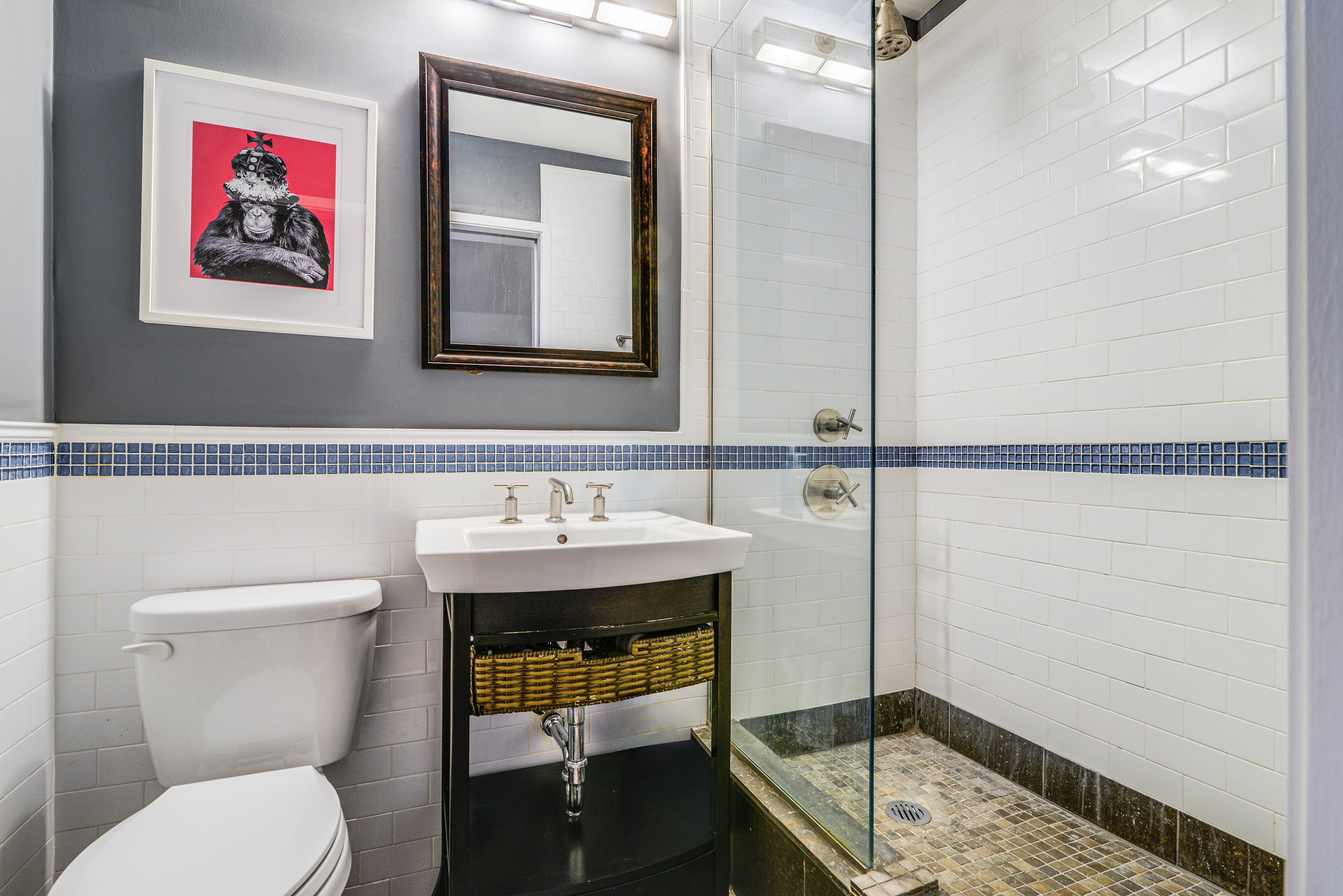 244 Madison Avenue, Unit 15J Manhattan, NY 10016 - Photo 7 of 11 a bathroom with a toilet a sink and mirror