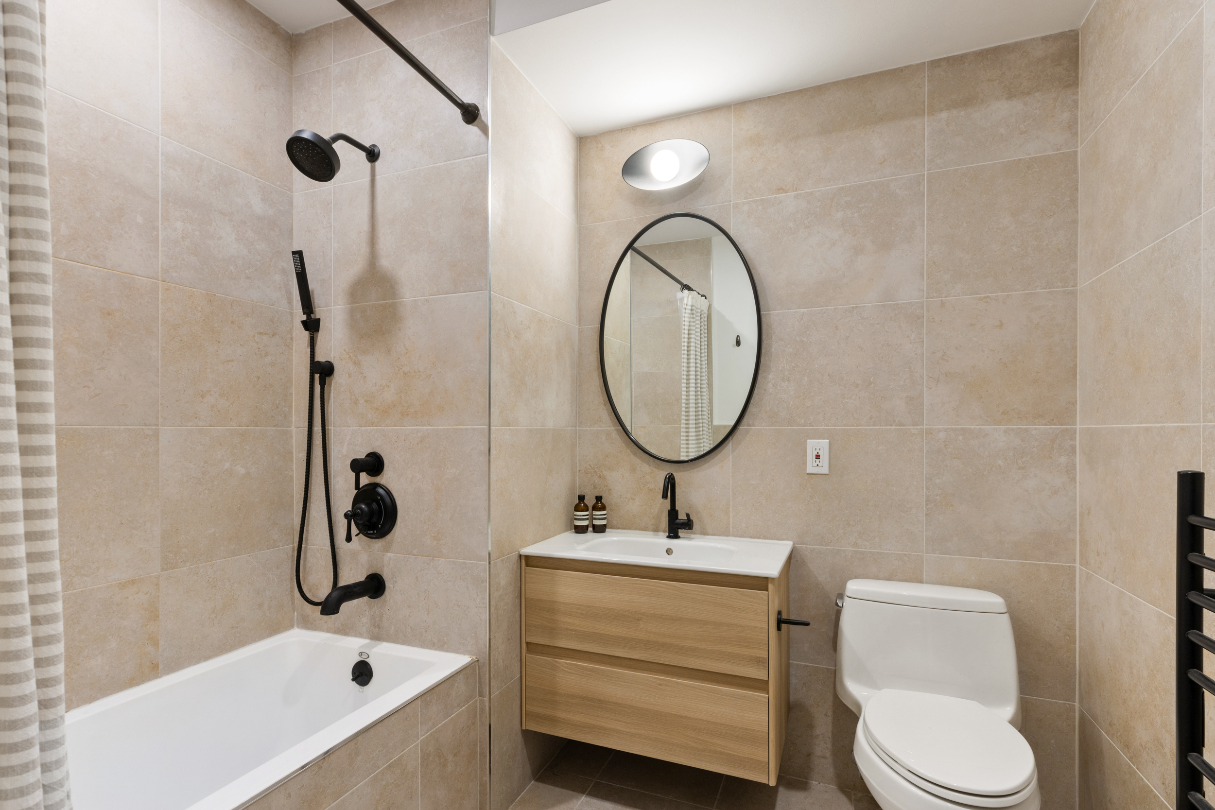 205 Freeman Street, Unit 3 Brooklyn, NY 11222 - Photo 5 of 9 a bathroom with a sink a toilet and a mirror