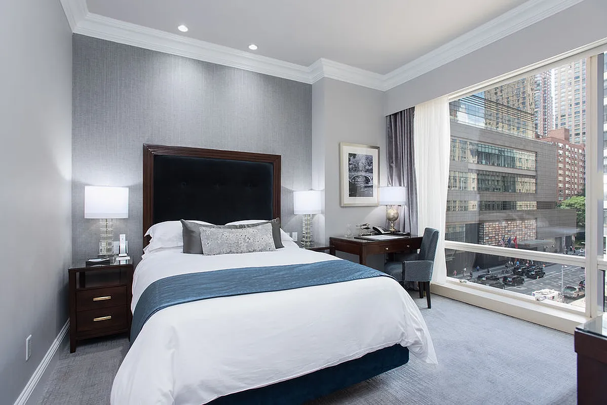 a bedroom with a large bed and a large window