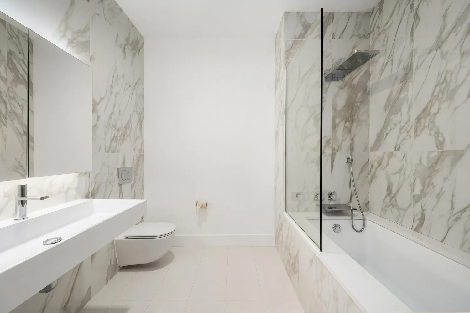 a bathroom with a tub sink toilet and a mirror