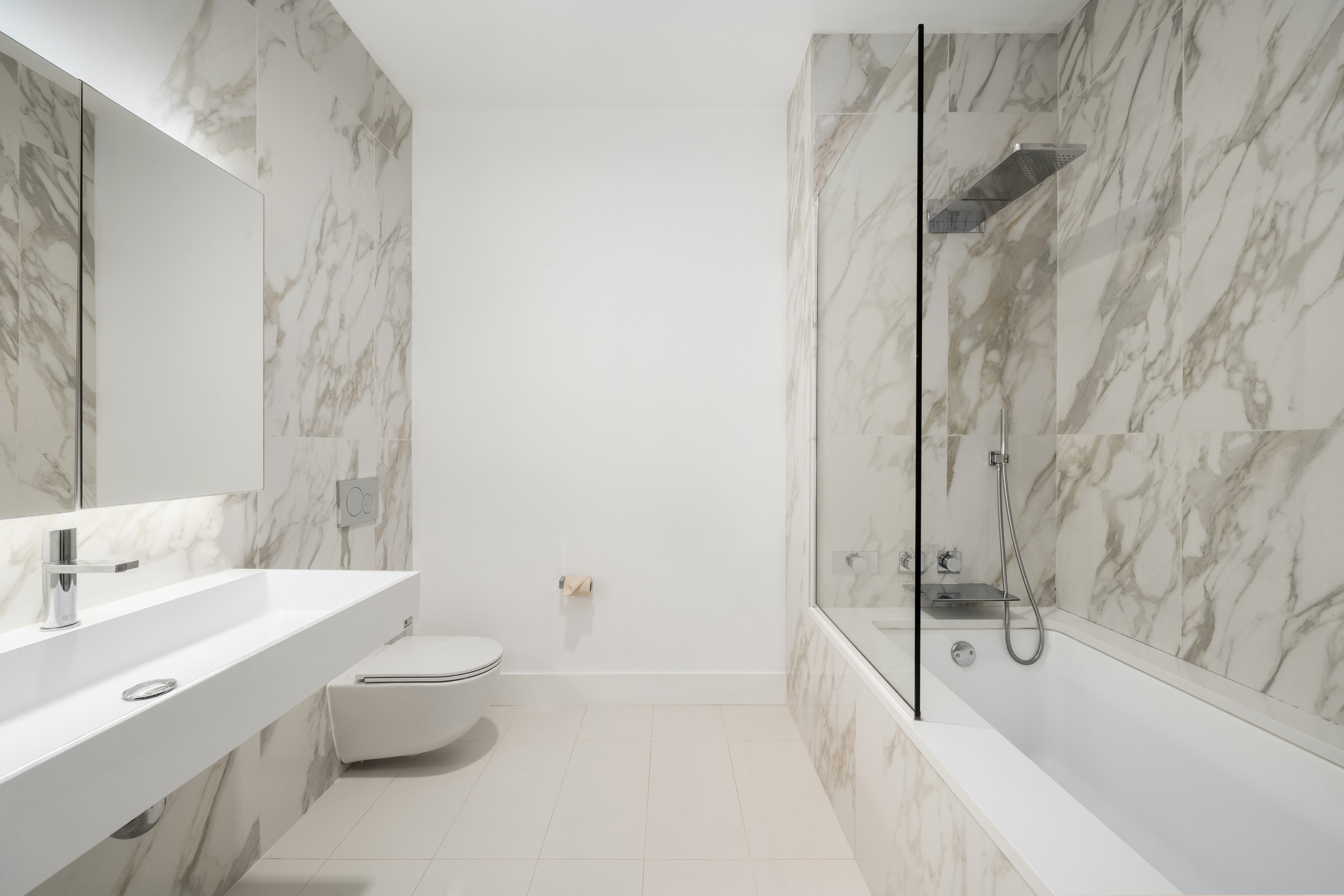 160 Imlay Street, Unit 4E3 Brooklyn, NY 11231 - Photo 7 of 12 a bathroom with a tub sink toilet and a mirror