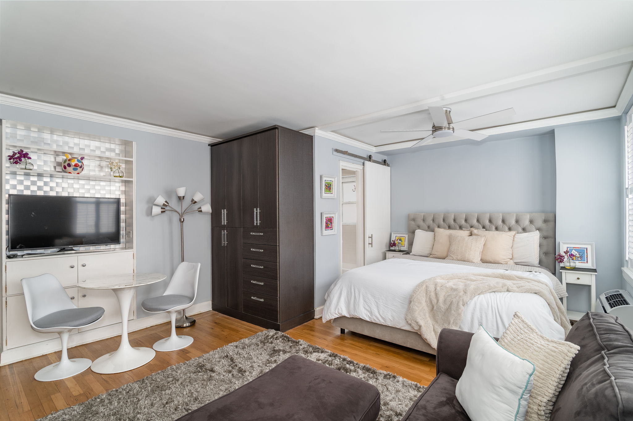 155 East 49th Street, Unit 10E Manhattan, NY 10017 - Photo 8 of 12 a bedroom with a bed and a flat screen tv