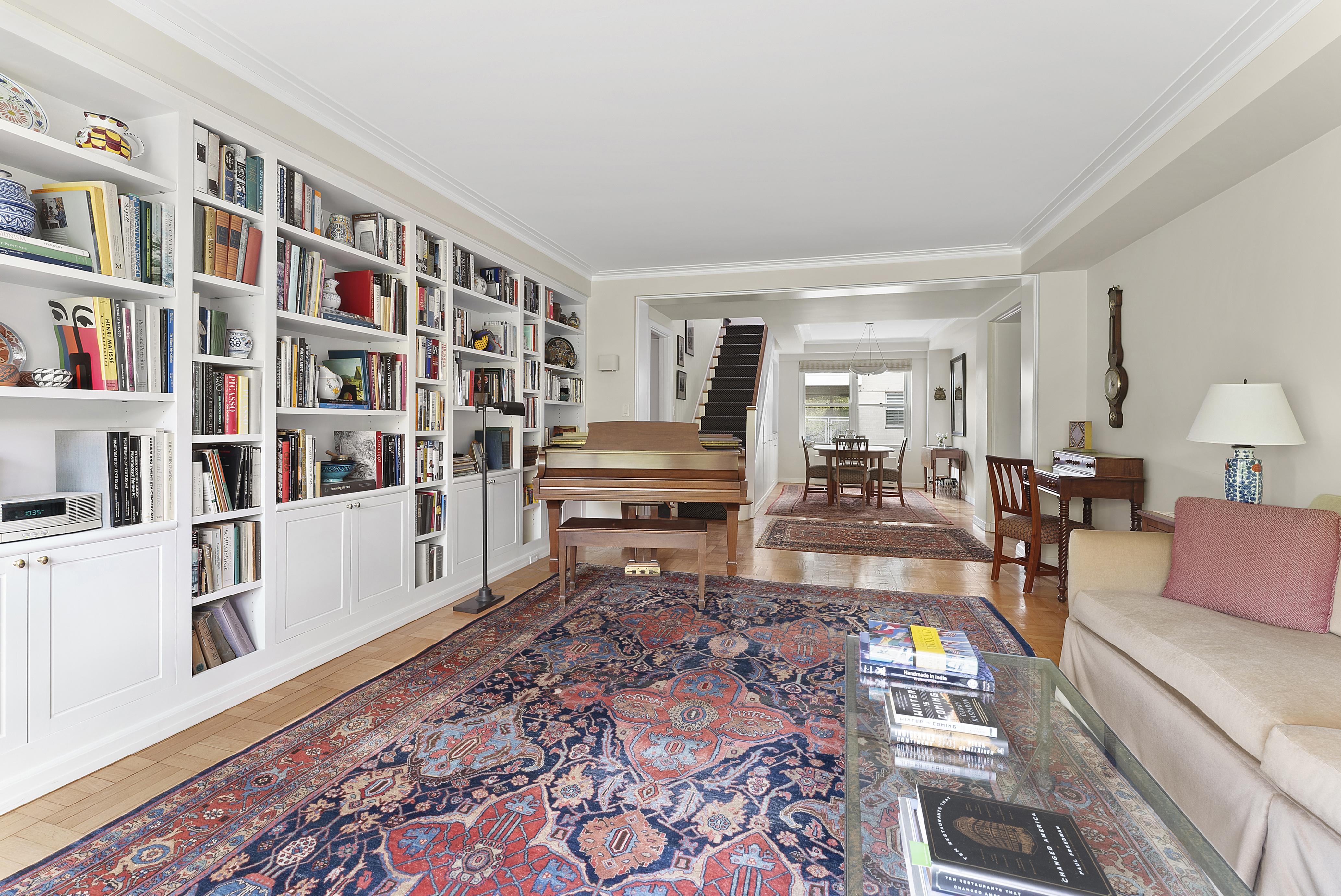 2 5th Avenue, Unit 55 Manhattan, NY 10011 - Photo 6 of 20 a living room with furniture and a book shelf